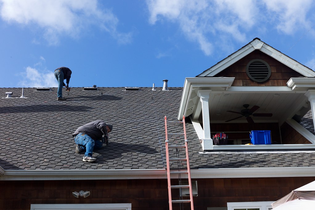 Roofing experts at work in Covington, LA, providing reliable roofing services​.